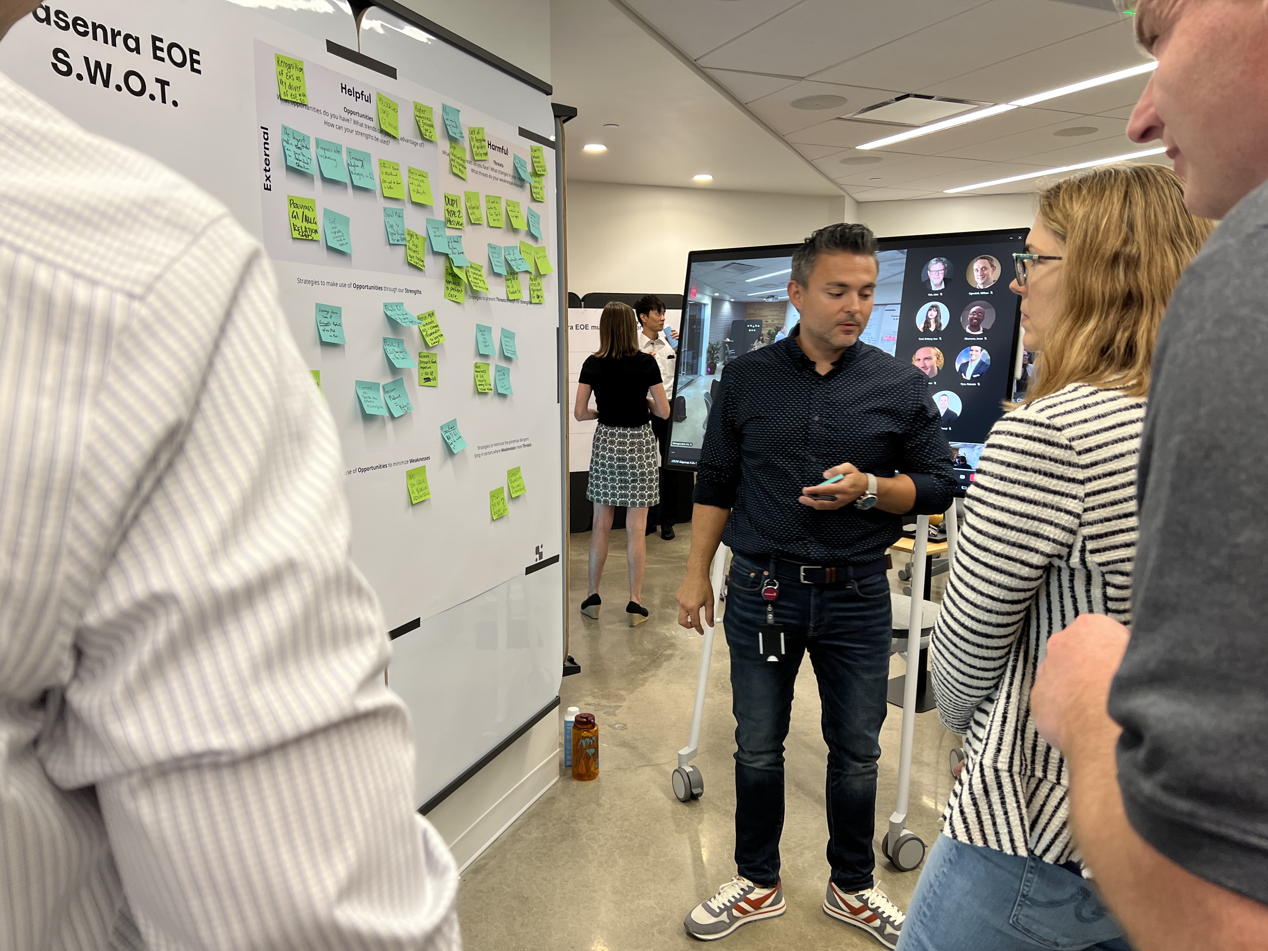 Image of a design workshop with a man standing next to a whiteboard.