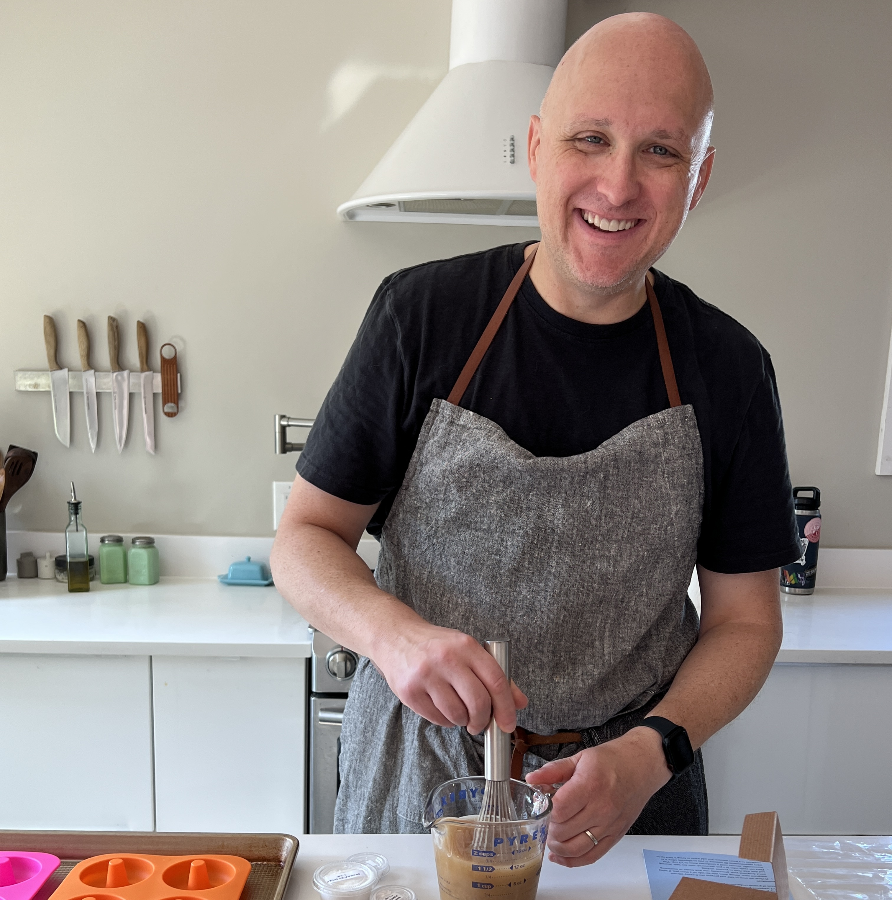 A man making donuts in his kitchen.