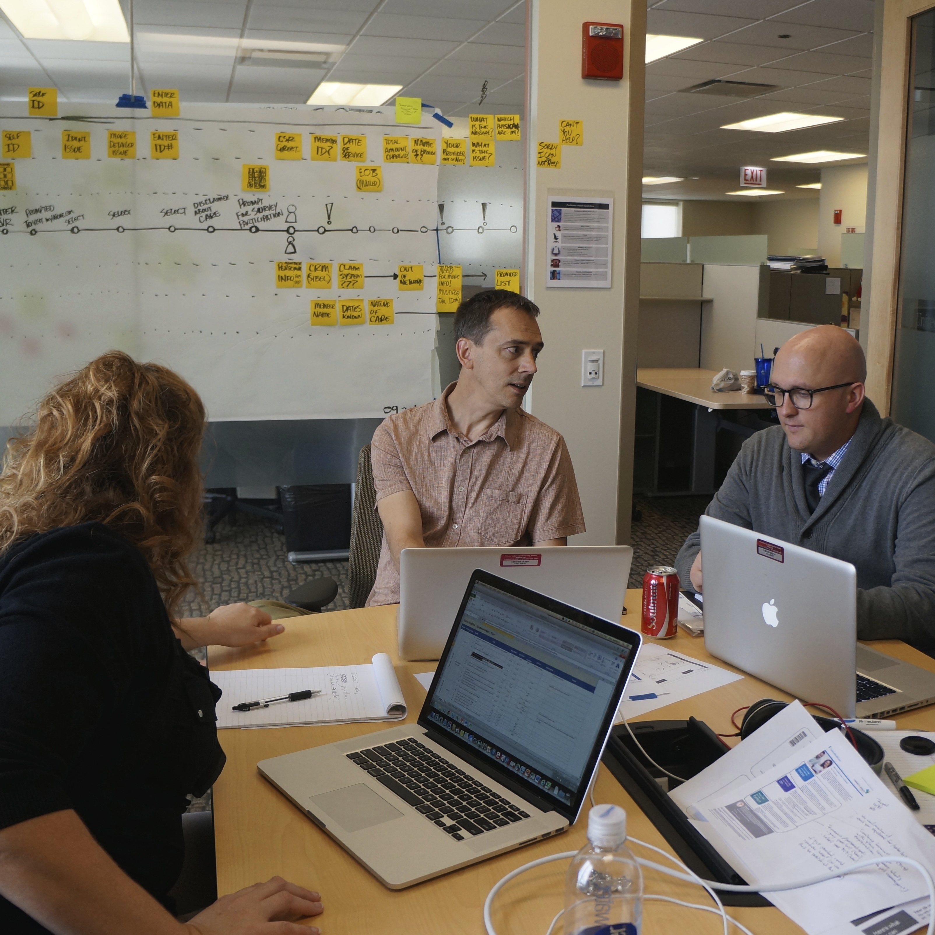 A worksession with three team members collaborating in a conference room.